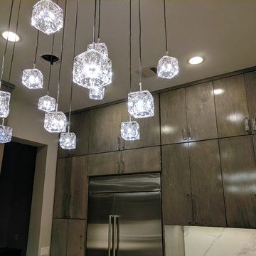 Contemporary kitchen cabinets and chandelier