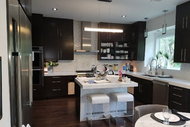 Inspiration for a mid-sized contemporary l-shaped eat-in kitchen remodel in Austin with an undermount sink, flat-panel cabinets, dark wood cabinets, quartz countertops, white backsplash, glass tile backsplash, stainless steel appliances and an island