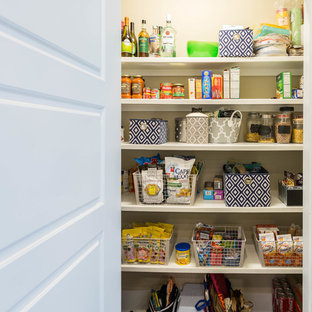 Mid-sized contemporary kitchen pantry inspiration - Inspiration for a mid-sized contemporary bamboo floor kitchen pantry remodel in Tampa with a farmhouse sink, white cabinets, wood countertops, white backsplash, ceramic backsplash and no island
