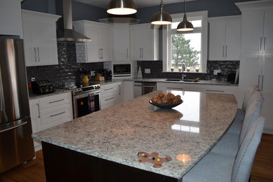 Large l-shaped medium tone wood floor eat-in kitchen photo in Other with an undermount sink, white cabinets, granite countertops, gray backsplash, subway tile backsplash, stainless steel appliances and an island