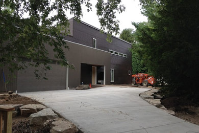Example of a mid-sized minimalist brown two-story metal exterior home design in Detroit with a shed roof