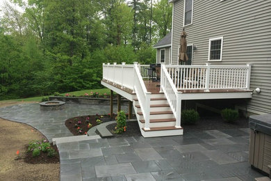Mid-sized elegant backyard deck photo in Boston with a fire pit and no cover