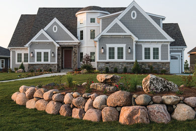 Example of a large trendy gray exterior home design in Other