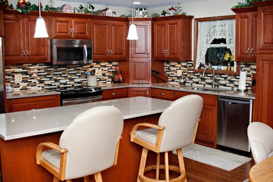 Elegant l-shaped eat-in kitchen photo in Other with an undermount sink, raised-panel cabinets, medium tone wood cabinets, quartz countertops, stainless steel appliances and an island