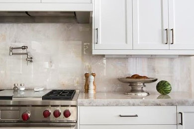 Inspiration for a mid-sized transitional dark wood floor and brown floor enclosed kitchen remodel in Other with an undermount sink, recessed-panel cabinets, white cabinets, quartz countertops, white backsplash, stone slab backsplash, stainless steel appliances and an island