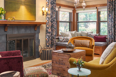 Mid-sized arts and crafts enclosed living room in Minneapolis with beige walls, medium hardwood floors, a standard fireplace, a stone fireplace surround and no tv.