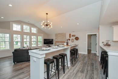 Living room - mid-sized contemporary open concept medium tone wood floor and gray floor living room idea in Tampa with a standard fireplace, a stone fireplace and a wall-mounted tv