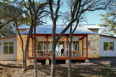 Small contemporary one-story stone gable roof idea in Austin