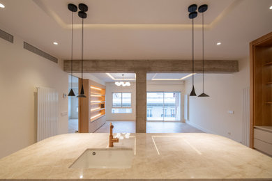Example of a mid-sized minimalist l-shaped open concept kitchen design in Madrid with an island