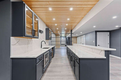 Inspiration for a mid-sized contemporary galley light wood floor and beige floor eat-in kitchen remodel in Philadelphia with a drop-in sink, flat-panel cabinets, blue cabinets, marble countertops, multicolored backsplash, marble backsplash, stainless steel appliances, an island and multicolored countertops