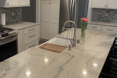 Quartzite kitchen countertops, tile backsplash , white shaker cabinetry