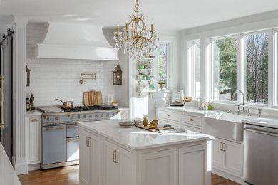 Example of a mid-sized classic galley light wood floor kitchen design in Portland Maine with a farmhouse sink, quartz countertops, white backsplash, porcelain backsplash and white countertops