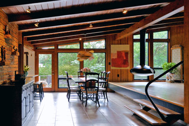 Inspiration for a large 1960s travertine floor, beige floor, exposed beam and wood wall great room remodel in Austin with brown walls