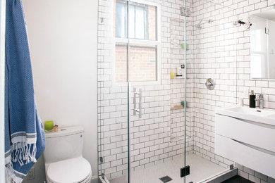 Design ideas for a mid-sized transitional master bathroom in San Francisco with white cabinets, an alcove shower, a two-piece toilet, white tile, subway tile, white walls, ceramic floors and an integrated sink.
