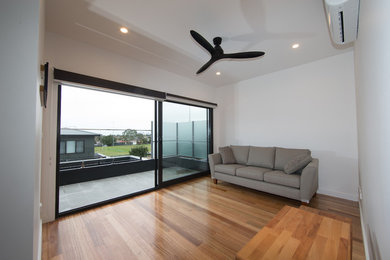 This is an example of a modern family room in Melbourne.