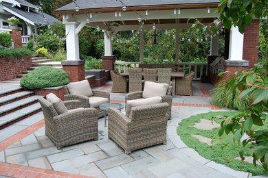 Inspiration for a mid-sized traditional backyard patio in Portland with an outdoor kitchen, natural stone pavers and a gazebo/cabana.