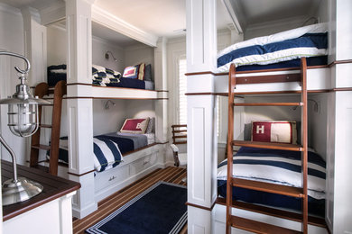 Example of a beach style gender-neutral carpeted kids' room design in Raleigh with white walls