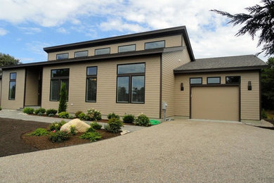 Example of a mid-sized trendy beige two-story concrete fiberboard exterior home design in Boston