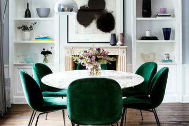 Medium sized classic enclosed dining room in London with blue walls, dark hardwood flooring, a standard fireplace, a stone fireplace surround, brown floors and feature lighting.