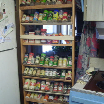 Spice rack on wheels rolls in beside fridge when not in use