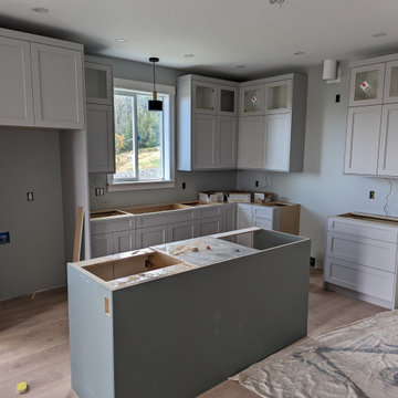 Kitchen renovation with upper cabinets and island being installed
