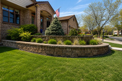 Inspiration for a mid-sized drought-tolerant and full sun front yard concrete paver retaining wall landscape in Denver for summer.