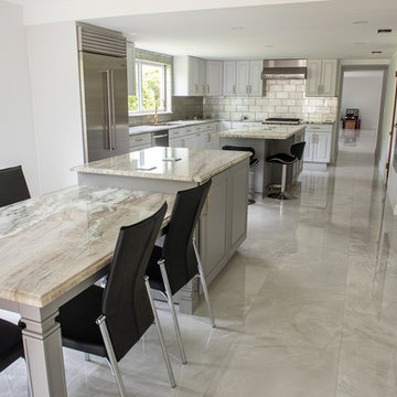 Transitional Kitchen Done in a 2 Tone Color With Integrated Dining Table