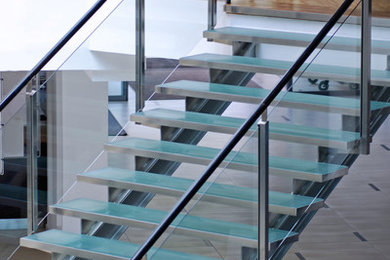 Example of a large minimalist glass straight open staircase design in Toronto