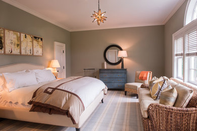 Large trendy guest medium tone wood floor bedroom photo in New York with green walls and no fireplace