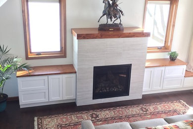 Example of a trendy dark wood floor living room design in Other with white walls, a standard fireplace, a tile fireplace and no tv