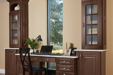 Example of a mid-sized transitional built-in desk medium tone wood floor home office design in Orange County with beige walls