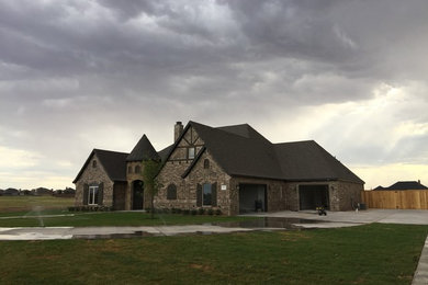 Inspiration for a mid-sized timeless brown two-story brick exterior home remodel in Orange County with a shingle roof