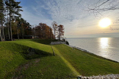 Design ideas for a huge coastal full sun backyard retaining wall landscape in Grand Rapids.