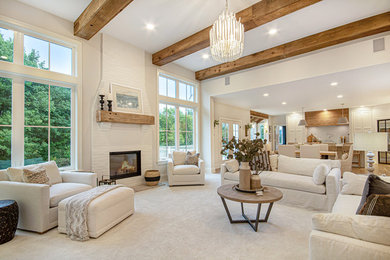 Inspiration for a transitional open concept medium tone wood floor and brown floor living room remodel in Grand Rapids with white walls and a standard fireplace
