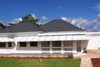Inspiration for a large and white beach style bungalow render and front house exterior in Other with a metal roof and a grey roof.