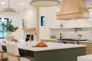 Inspiration for a large transitional l-shaped light wood floor open concept kitchen remodel in Seattle with a farmhouse sink, shaker cabinets, green cabinets, quartz countertops, white backsplash, quartz backsplash, paneled appliances, two islands and white countertops