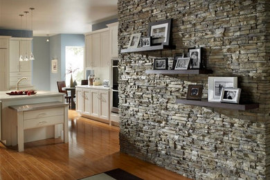 Kitchen - mid-sized u-shaped light wood floor and brown floor kitchen idea in Other with recessed-panel cabinets and stainless steel appliances