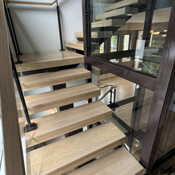 Project #136 | Modern Floating Staircase Encircling Glass Elevator