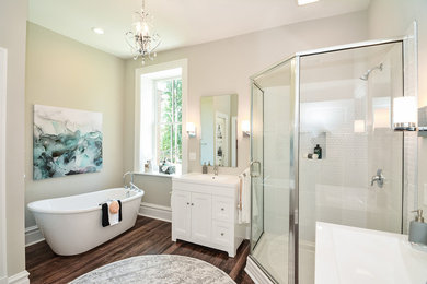 Inspiration for a large master white tile and ceramic tile dark wood floor bathroom remodel in St Louis with shaker cabinets, white cabinets, a two-piece toilet, gray walls, an integrated sink and a hinged shower door