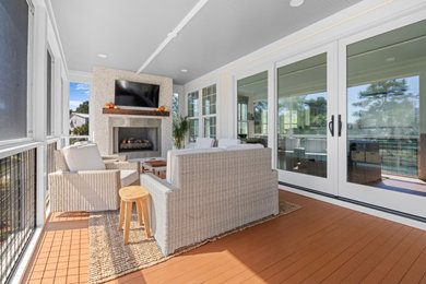 Inspiration for a large contemporary screened-in back porch remodel in Charleston with decking and a roof extension