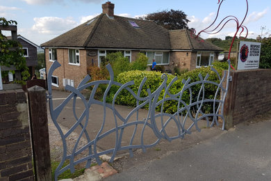 Contemporary garden in Sussex with a metal fence.