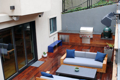 This is an example of a small backyard patio in San Francisco with an outdoor kitchen and decking.