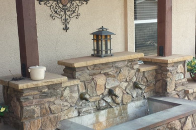 Tuscan backyard patio fountain photo in Phoenix with a pergola