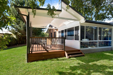 Photo of a contemporary backyard deck in Canberra - Queanbeyan with a roof extension.