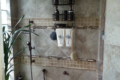 Example of a mid-sized transitional beige tile and terra-cotta tile alcove shower design in Dallas