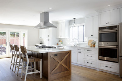 Mid-sized transitional galley open concept kitchen photo in San Francisco with shaker cabinets, medium tone wood cabinets, quartz countertops, white backsplash, an island and white countertops