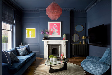 Photo of a large contemporary open plan living room in London with blue walls, dark hardwood flooring, a standard fireplace, a stone fireplace surround, a wall mounted tv and brown floors.