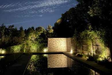 This is an example of a large contemporary backyard rectangular pool in Melbourne with with a pool and tile.