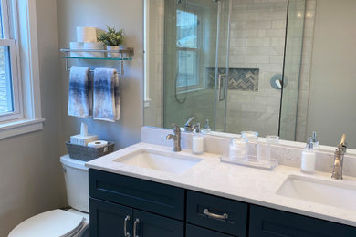 Example of a transitional master white tile and ceramic tile ceramic tile, blue floor and double-sink bathroom design in Philadelphia with shaker cabinets, blue cabinets, a one-piece toilet, gray walls, an undermount sink, quartz countertops, white countertops, a niche and a freestanding vanity
