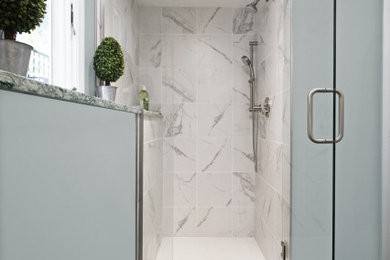Small transitional 3/4 white tile and porcelain tile porcelain tile and black floor alcove shower photo in Boston with shaker cabinets, white cabinets, a two-piece toilet, blue walls, an undermount sink, quartz countertops and a hinged shower door